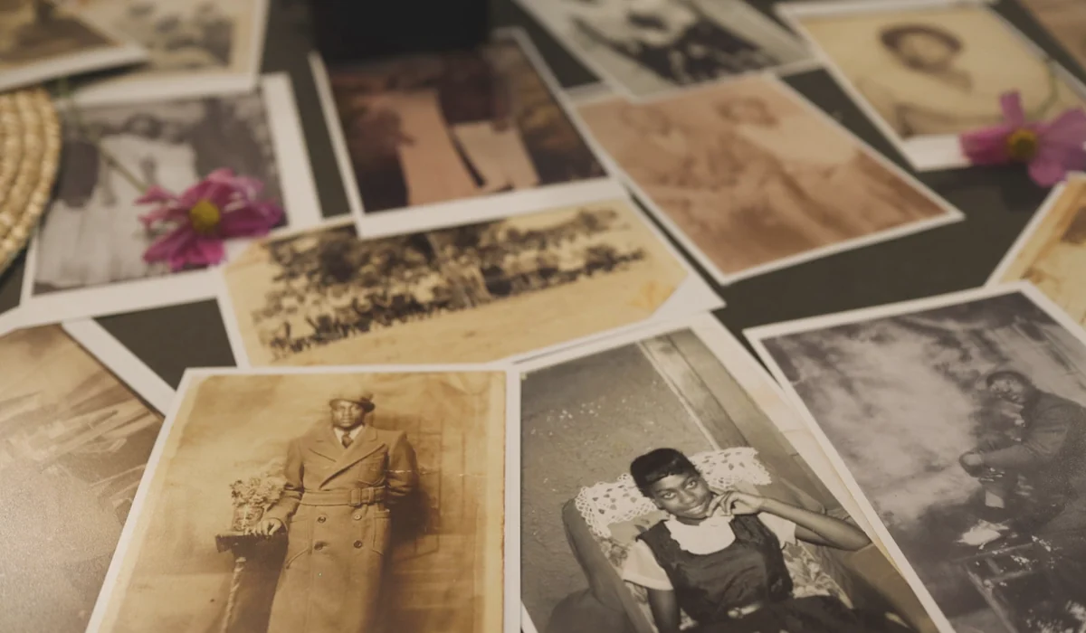 A collection of vintage sepia photographs scattered on a table, evoking nostalgia.